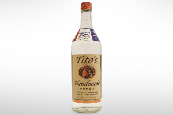 Tito's vodka bottle with a custom orange cap designed by Spartek.